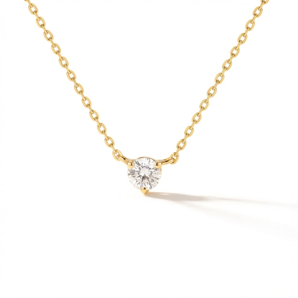 Dainty 14Kt gold chain necklace with a sparkling round zirconia solitaire pendant.