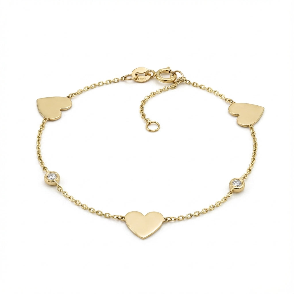 14Kt gold bracelet with three heart charms and two bezel-set diamonds, dainty luxury jewelry for women. product photo by Morelove Designs