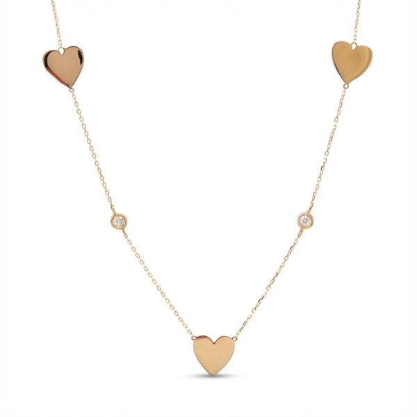 14Kt gold necklace with three heart charms and two bezel-set diamonds product photo by Morelove Designs