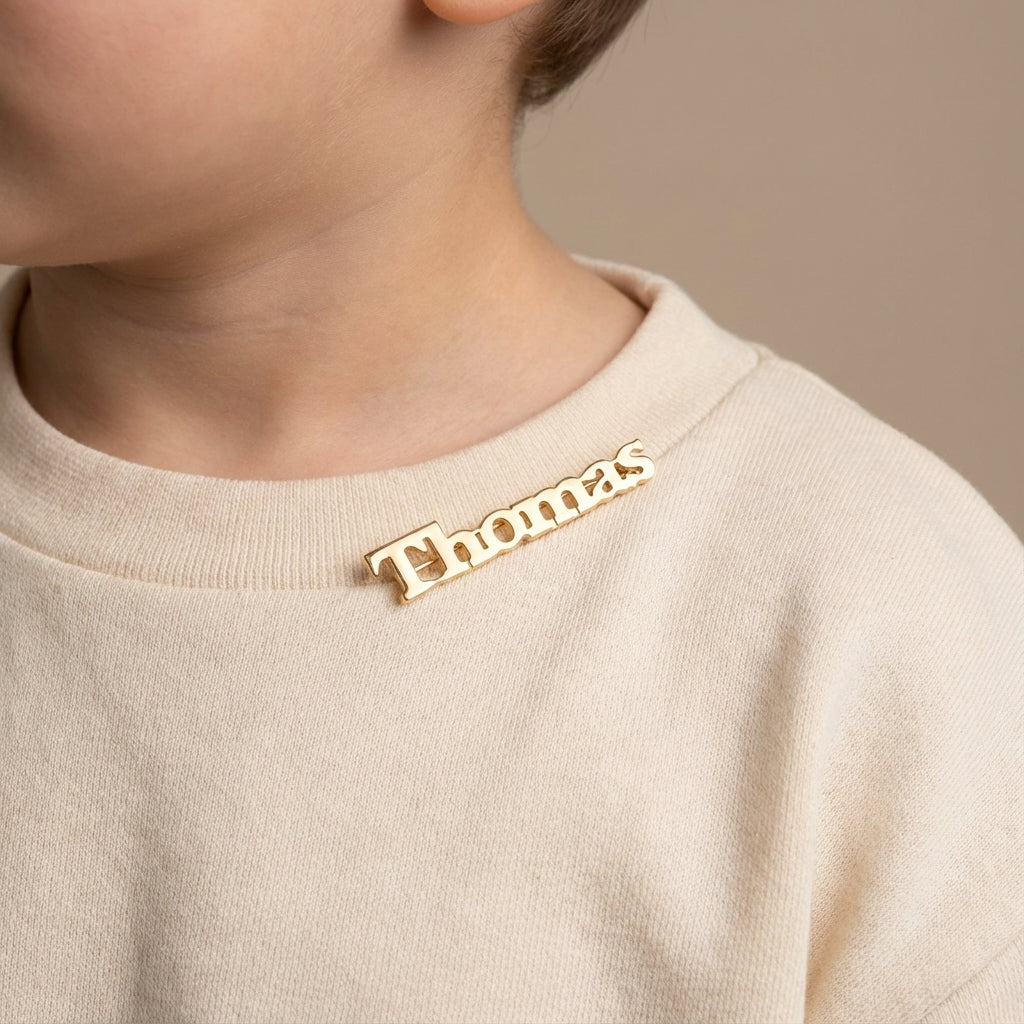 Personalized 14K gold block name safety pin, custom baby jewelry gift. photography by Morelove Designs