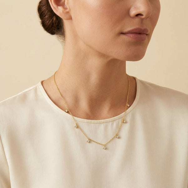 Elegant golden plated silver dangle necklace featuring sparkling square-cut stones, ideal for women's everyday fine jewelry.