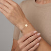 14Kt gold bracelet with three heart charms and two bezel-set diamonds, dainty luxury jewelry for women. photography by Morelove Designs
