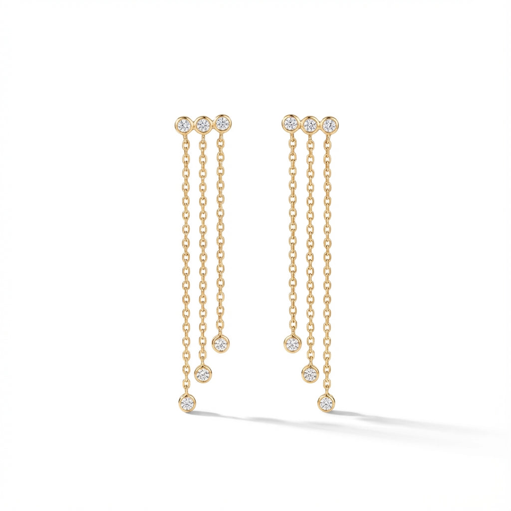 Elegant 14Kt gold diamond fringe earrings, featuring three delicate chains with diamond drops on a woman's earlobe.