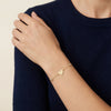 14Kt gold bracelet with three heart charms and two bezel-set diamonds, dainty luxury jewelry for women. photography by Morelove Designs