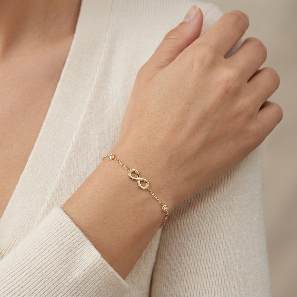 14Kt gold bracelet with three heart charms and two bezel-set diamonds, dainty luxury jewelry for women. photography by Morelove Designs