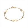 14Kt gold bracelet with three heart charms and two bezel-set diamonds, dainty luxury jewelry for women. product photo by Morelove Designs