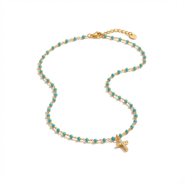 Golden Plated Silver necklace with small blue beads and a sparkling mini cross pendant.