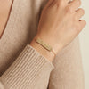 Personalized 14Kt gold name bar bracelet with side zircons, custom engraved jewelry photography by Morelove Designs