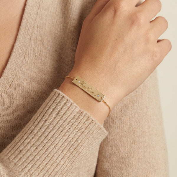 Personalized 14Kt gold name bar bracelet with side zircons, custom engraved jewelry photography by Morelove Designs