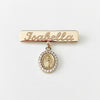 14Kt gold personalized name bar safety pin, "Isabella" engraved, with mini Miraculous Medal charm for kids. product photo by Morelove Designs
