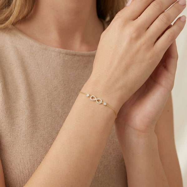 14Kt gold infinity bracelet with pave diamonds; delicate wrist jewelry for adults. photography by Morelove Designs