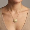 Luxury everyday fine jewelry: round diamond and 14K gold Miraculous Medal pendant.