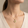 Gold 14Kt round medallion pendant with sparkling diamonds, perfect for personalization or gifts. photography by Morelove Designs