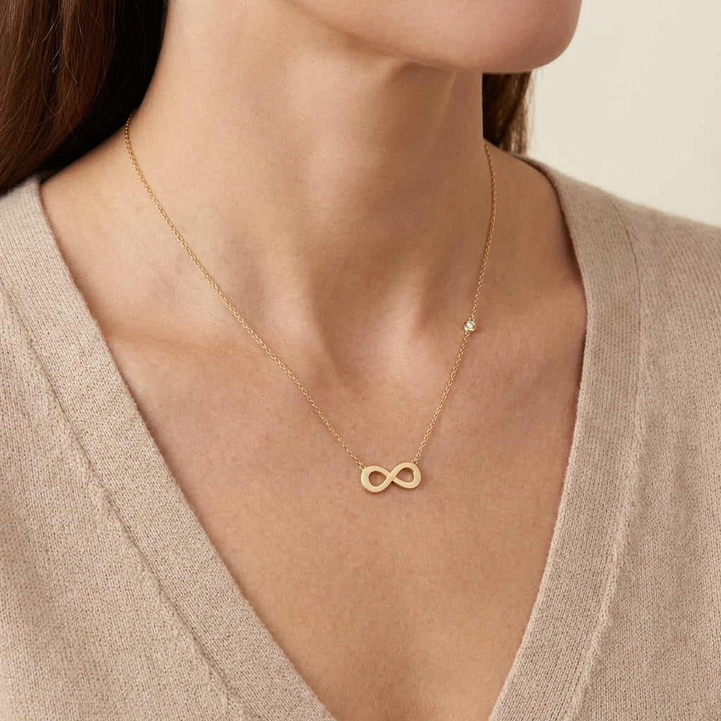 14kt gold infinity necklace with a delicate side bezel diamond, elegant fine jewelry for women photography by Morelove Designs