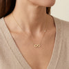 14kt gold infinity necklace with a delicate side bezel diamond, elegant fine jewelry for women photography by Morelove Designs