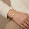 14Kt gold bracelet with three heart charms and two bezel-set diamonds, dainty luxury jewelry for women. photography by Morelove Designs
